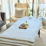 6-Minute Groceries and Massages at My Door: Life in the UAE Massage table with fresh white linens set up in a bright living room.